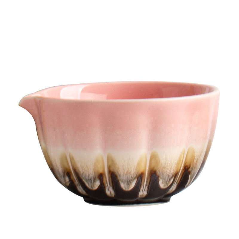 Close view of the pink fluted bowl, pouring spout and layered cream and dark glaze