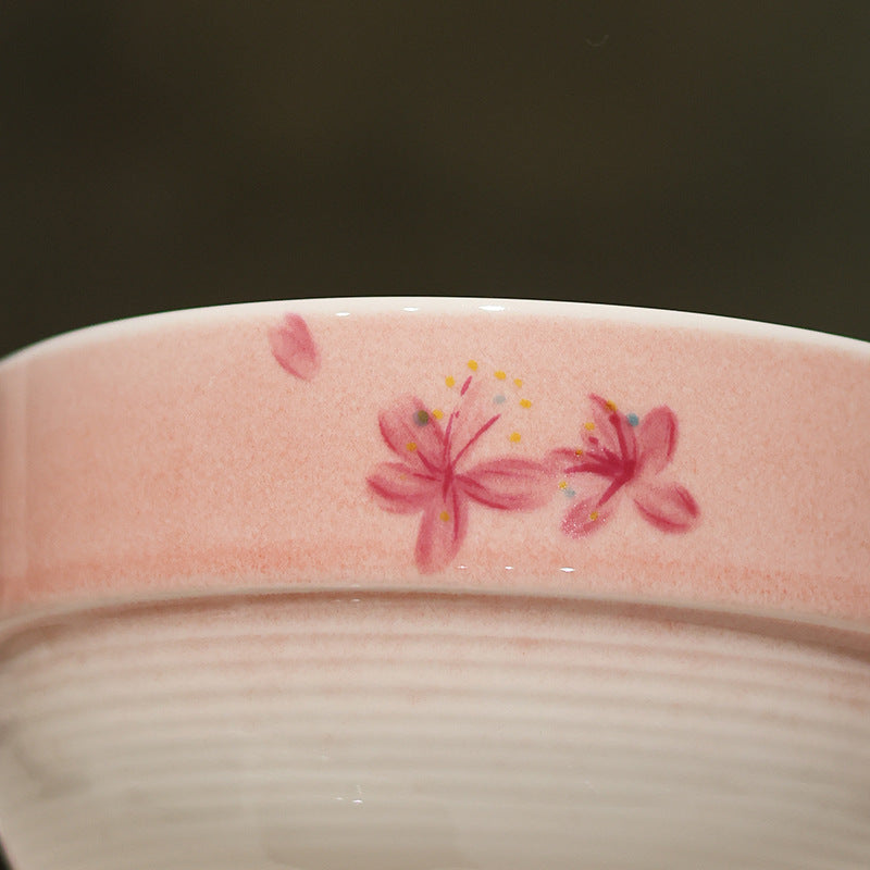 Close detail of pink blossom decoration and the smooth band above fine cream ridges