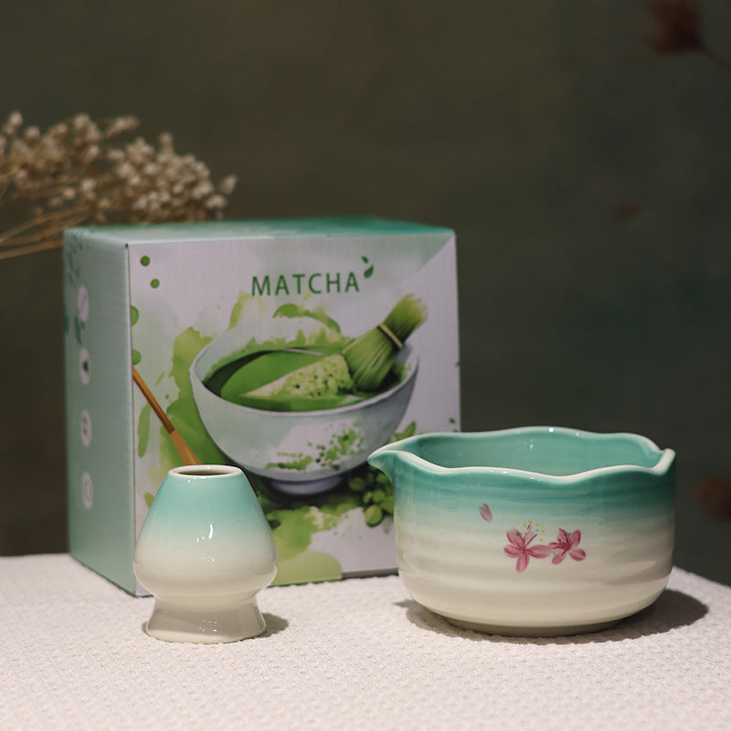 Green and white scalloped matcha bowl and matching whisk holder in the two-piece box configuration