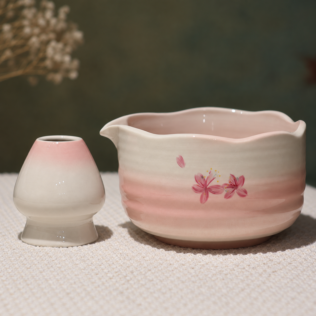 Close view of the pink blossom painting, scalloped pouring rim and matching ceramic holder