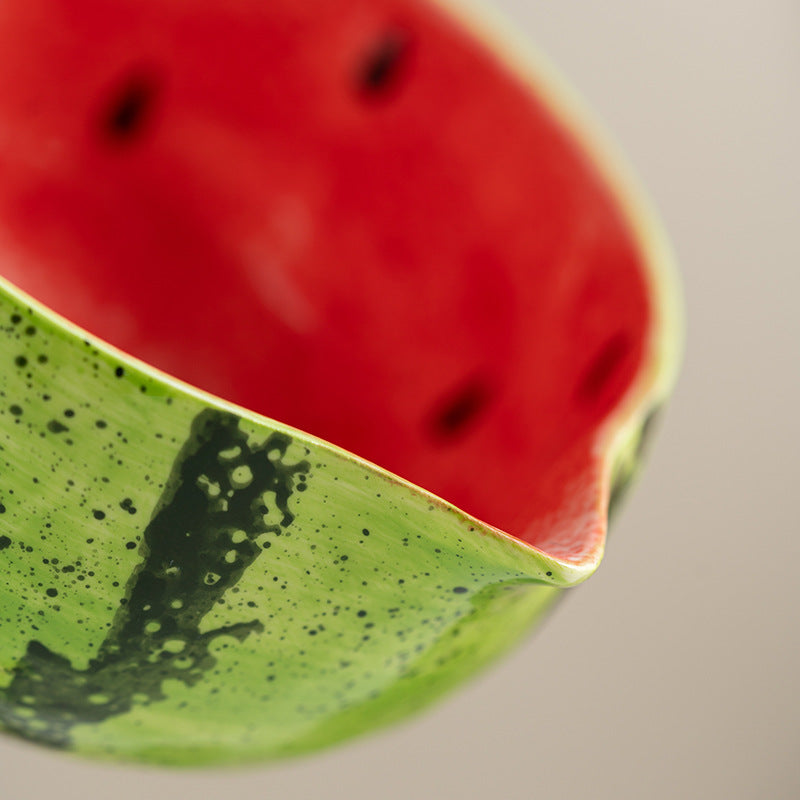 Close detail of the red watermelon bowl pouring lip and speckled green rind glaze