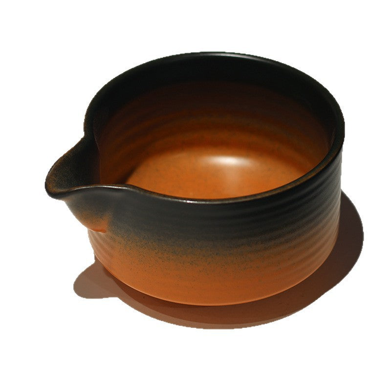 Close-up of the amber bowl interior, curved pouring spout and ribbed glaze