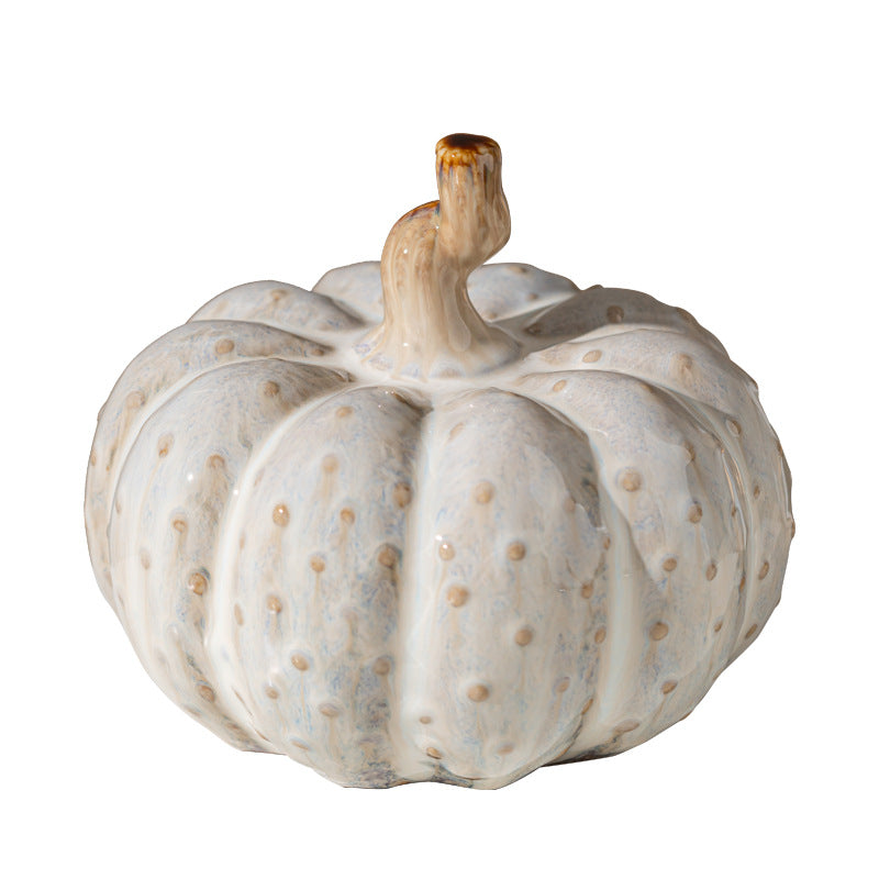 Ivory ceramic pumpkin ornament on a white background